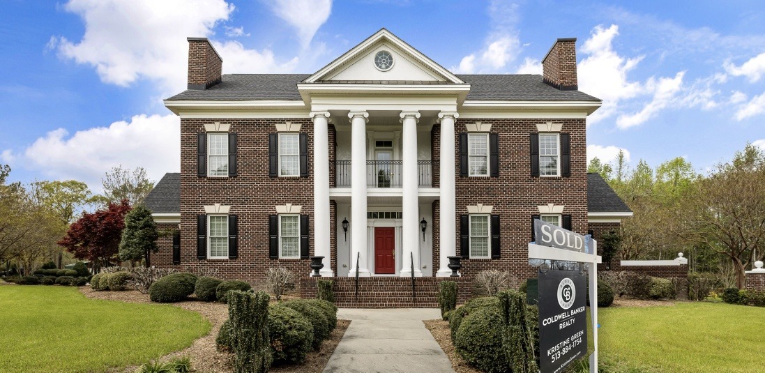 SOLD sign in front of a Greater Cincinnati luxury home, Kristine Green Coldwell Banker Realty