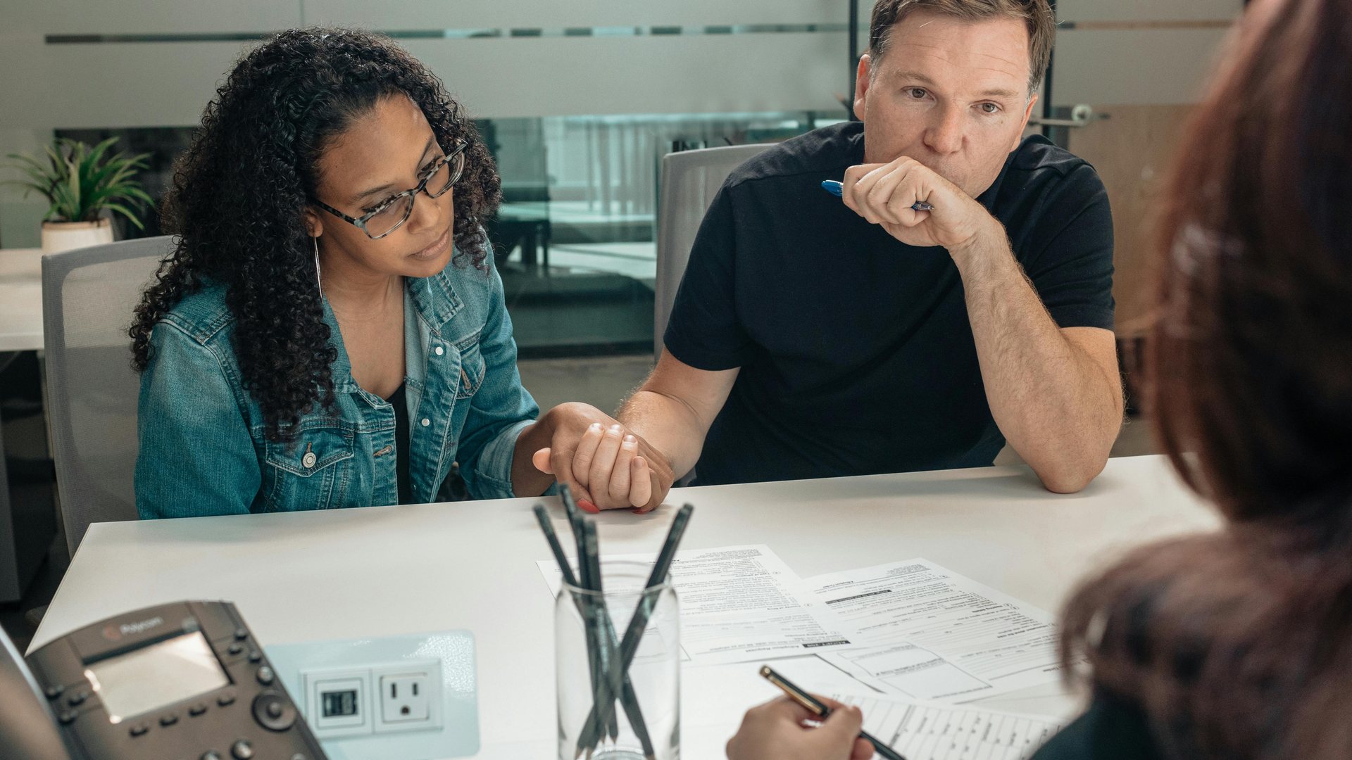 Home buyers meeting with a lender to review mortgage pre-approval paperwork before touring homes in Greater Cincinnati, Ohio